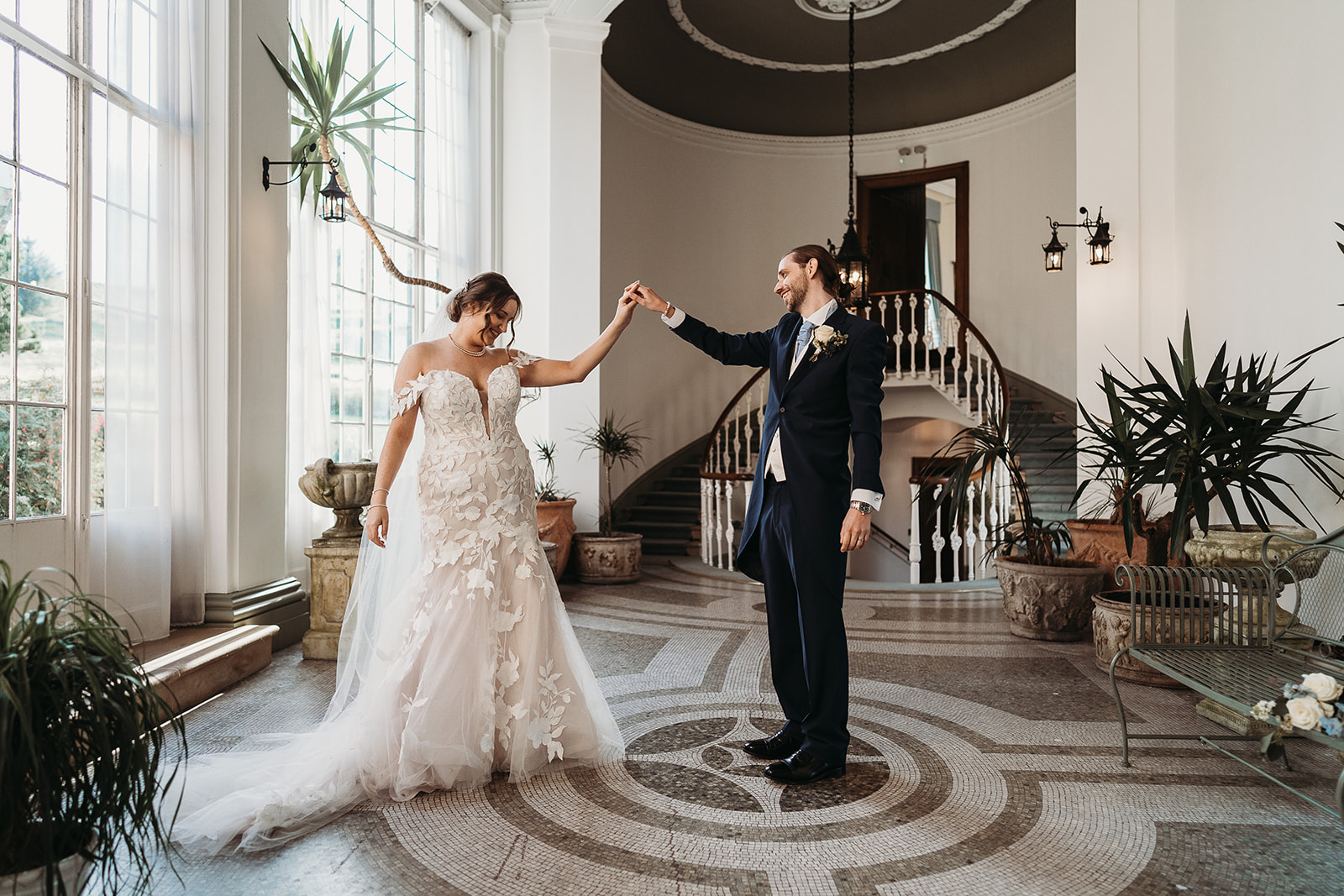 Bride and groom hand in hand at Shropshire wedding venue, Hawkstone Hall