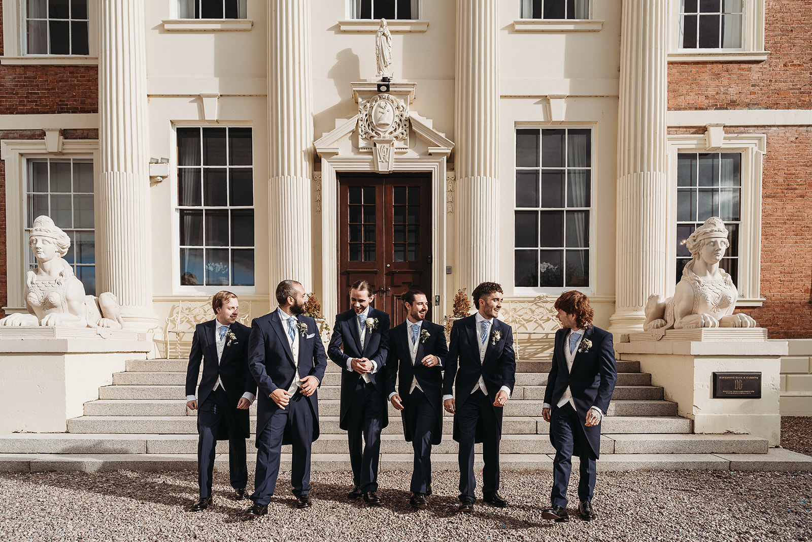 Groomsmen all standing outside of Shropshire wedding venue, Hawkstone Hall for their group photos