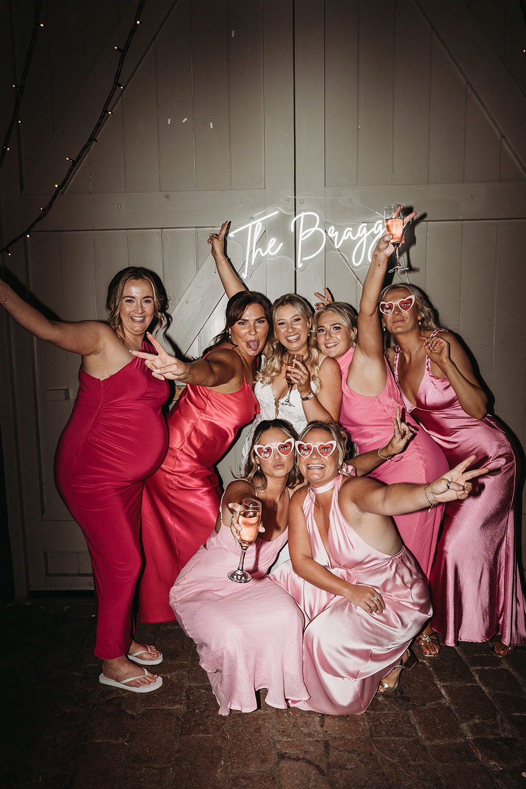 Wedding guests posing in front of signage at Shropshire wedding venue Pimhill Barn 