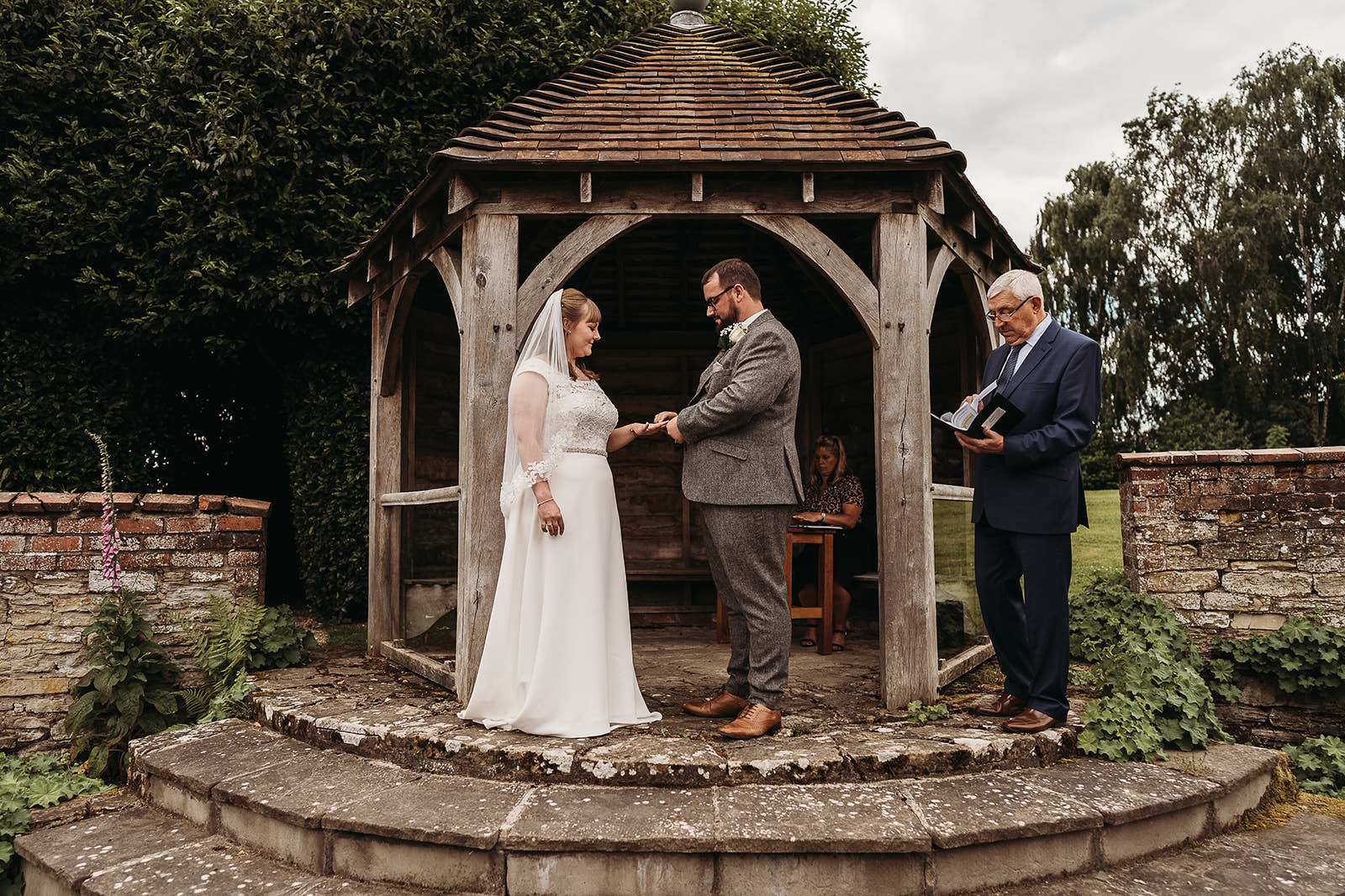 bride and groom marrying during outside ceremony at Shropshire wedding venue, Delbury Hall 