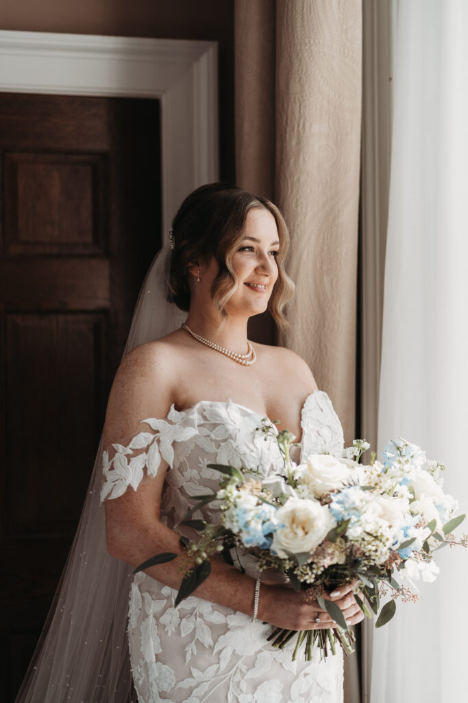 Bride portrait in window with natural light at Shropshire Venue, Hawkstone Hall 