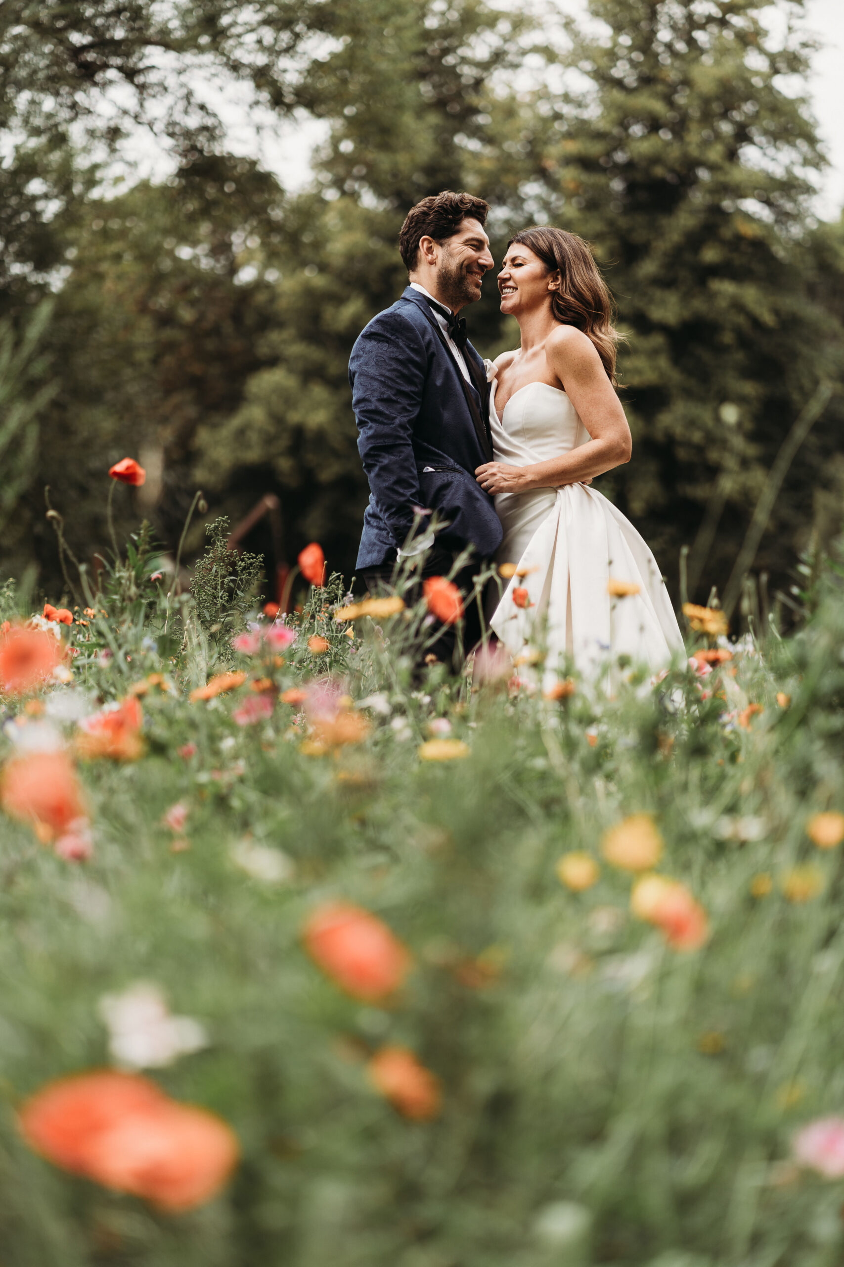 bride and groom in wild flower meadow in the gardens of Shropshire wedding venue, Garthmyl Hall 