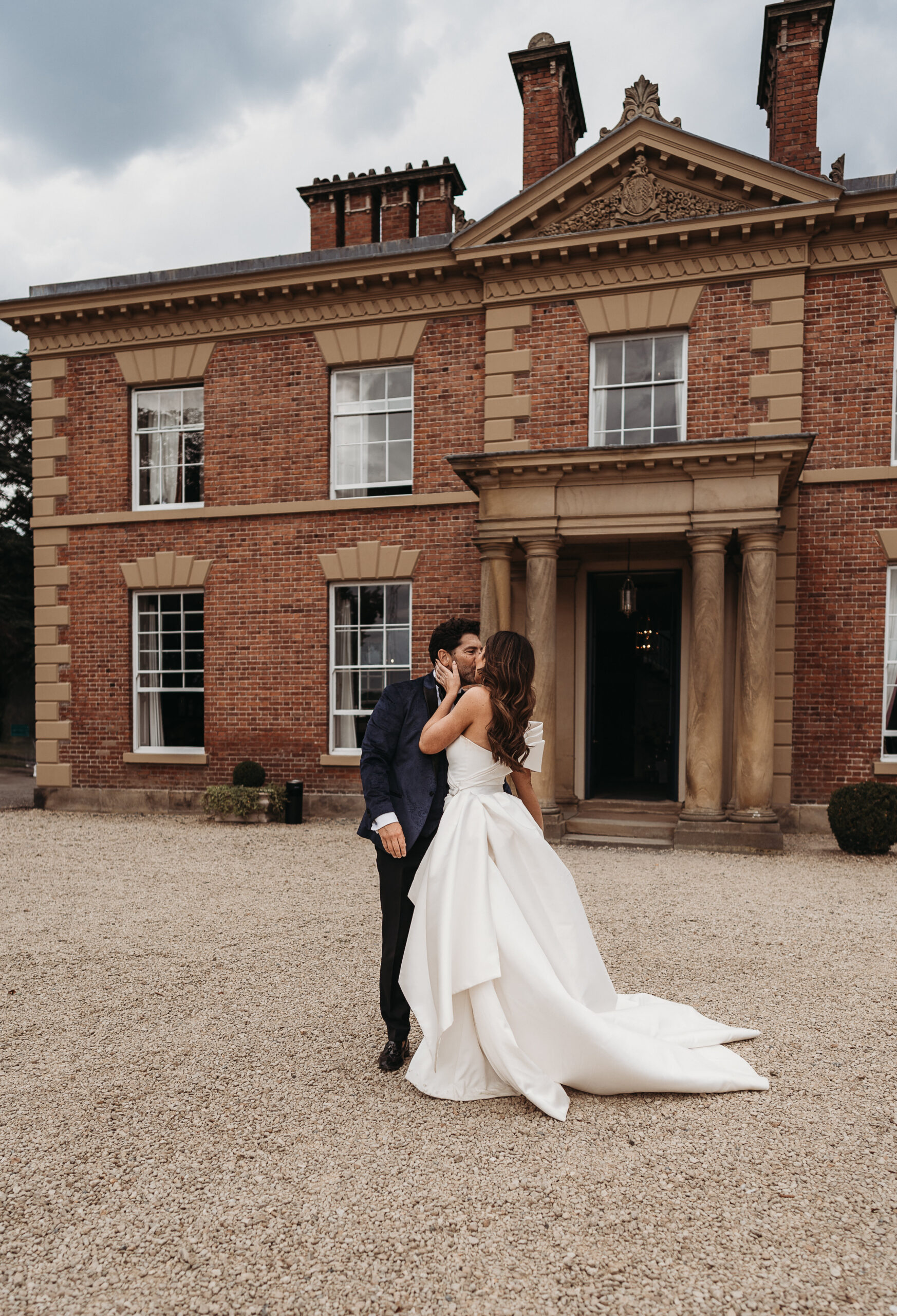 bride and groom portrait outside the front of Shropshire Wedding venue, Garthmyl Hall. 