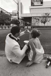 bride and groom eating pizza onna curb in las vegas